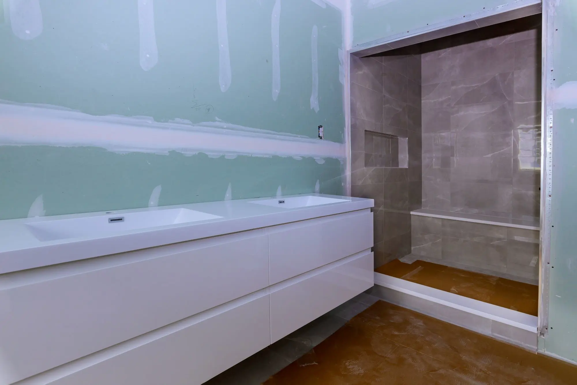 Bathroom remodel detail showing tile, lighting, and modern fixtures